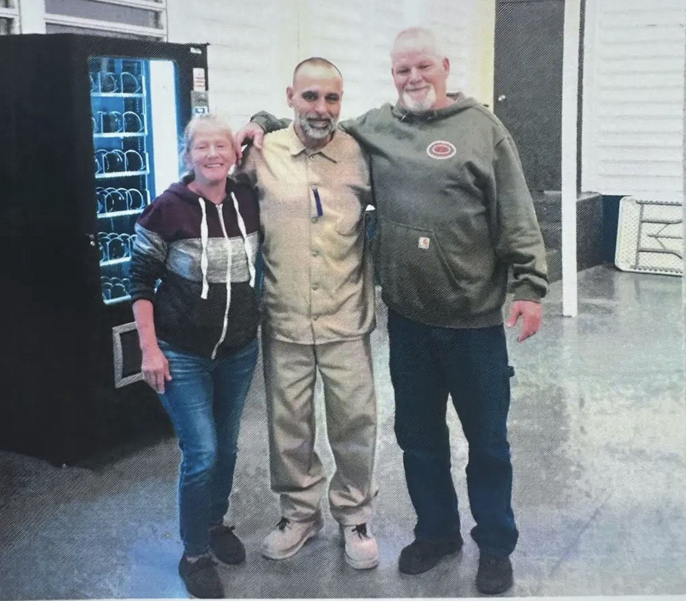 Mark Jenkins during a prison visit in 2024, standing between his brother Billy and Billy's friend