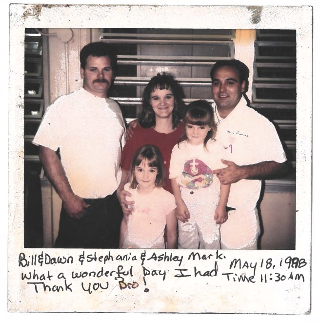 A photograph of Mark Jenkins with his brother's family during a prison visit in 1998, inscribed in Mark's handwriting